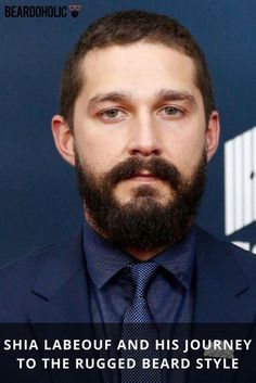 a man with a goatee and beard wearing a blue suit is looking at the camera