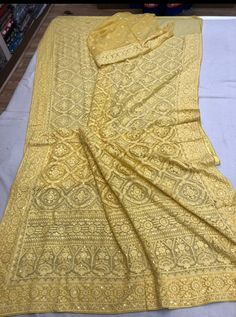 Update! - Zynah covered by LBB - https://lbb.in/bangalore/zynah-designs-handloom-sarees/ Pure Georgette Saree with intricate thread chikankari work. Beautiful motifs like flowers and diamonds are made using different kind of stitches. Sequence handwork is done through out the saree as a highlighter to enhance the beauty of saree. Dyeable to any shade as per your choice and contrast color blouse piece can be provided on demand Length: 5.5 meters Width: 1.2 meters Blouse: Running/attached with sar Gold Chikankari Embroidery Anarkali Set For Navratri, Gold Chikankari Anarkali Set For Navratri, Gold Anarkali Set With Chikankari Embroidery Bollywood Style, Gold Bollywood Style Chikankari Embroidered Anarkali Set, Bollywood Gold Chikankari Anarkali Set, Elegant Yellow Chinon Dupatta, Semi-stitched Gold Anarkali Set With Chikankari Embroidery, Gold Semi-stitched Anarkali Set With Chikankari Embroidery, Gold Lehenga With Chikankari Embroidery In Dola Silk