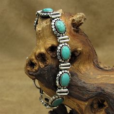 "Sterling silver and green turquoise toggle link bracelet. The bracelet is 7\" long. It is 7/16\" wide.  It has a second 3/8\" link on the end which will allow you to shorten the bracelet some.  The oval turquoise stones are 3/8\"long.  Silver dots surround the stone.  The links are 11/16\" long. This piece is guaranteed to be sterling silver. The bracelet is in good condition. Thank you for looking. Please let us know if you have questions. MS-20 k *The color you see on your screen may not refl Native American Fashion, Turquoise Stones, American Fashion, Hinged Bangle, Green Turquoise, Adjustable Bracelet, Chain Link Bracelet, Vintage Sterling Silver