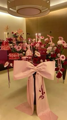 a table topped with lots of pink flowers and candles