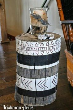 a bird sitting on top of a wooden stump with arrows painted on it's sides