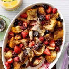 a bowl filled with french toast and berries