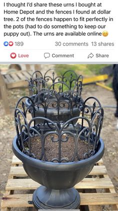 a large metal planter sitting on top of a wooden pallet