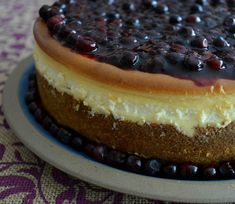 a cheesecake with blueberries on top is sitting on a plate