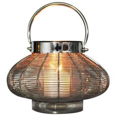 a small metal lantern with a handle on it