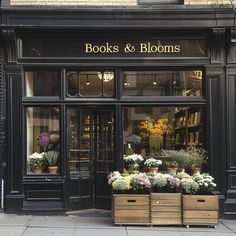 a store front with flowers in wooden boxes on the sidewalk outside and large windows that read books & blooms