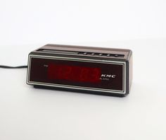 an alarm clock sitting on top of a white table