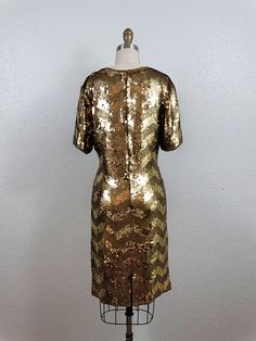 "This is a STUNNING little vintage dress! It's fully embellished with gold sequins in a retro chevron design and trimmed with gold beading. It's in perfect condition! Measurements: Bust - 34\" Waist - 27\" Hips - 36\" Dress Length - 37\" This dress comes from a pet-free and smoke-free home. If you would like more info or have any questions, please don't hesitate to ask!" Bridesmaid Dress Gold, Sequin Dress Gold, Gold Mini Dress, Sequined Mini Dress, Mini Gold Dress, Deco Dress, Gold Bridesmaid Dresses, Gold Sequin Dress, Dress Gold