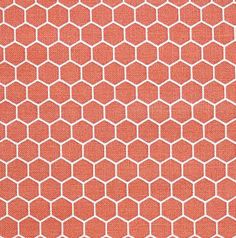 an orange and white rug with hexagonal shapes