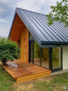 a small wooden house with a metal roof