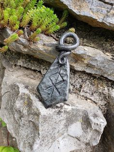 This bindrune pendant uses the Elder Futhark runes: Tiwaz, Othala, and Raidho to spell Thor, as it is in northern European languages (Tor). Hand forged to a drop-diamond shape, peined with a hammer to create texture, freehand chiseled to create the bindrune shown, and then carefully bent to create a wrapped bail for hanging. All of my pieces are coated with a durable linseed oil finish to create a richer color, as well as a robust rust resistance. Comes on an adjustable waxed cotton cord. Viking Accessories, Elder Futhark Runes, Futhark Runes, European Languages, Elder Futhark, Linseed Oil, Cotton Cord, Diamond Shape, Waxed Cotton