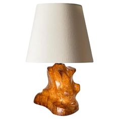 a table lamp made out of wood with a white shade on the top and bottom