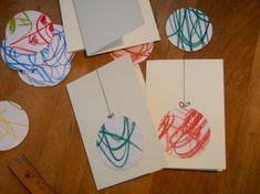 four different colored handmade cards on a wooden table