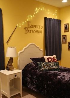 a bedroom decorated in yellow and purple with pictures on the wall