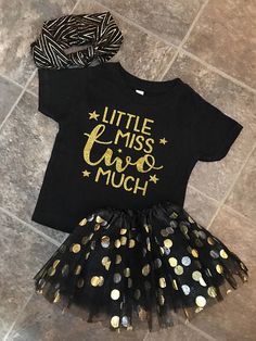 a black shirt with gold glitters on it and a tutu skirt for girls