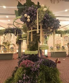 a very large flower arrangement in the middle of a room