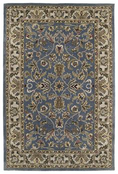 a blue and beige rug with an ornate design