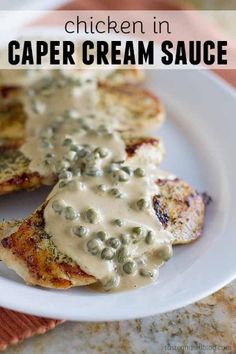 chicken in caper cream sauce on a white plate with text overlay that reads chicken in caper cream sauce