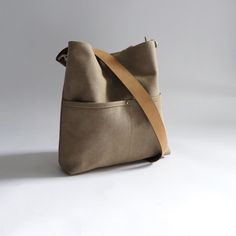 Urban-chic style crossbody bags that are neutral in color and effortlessly casual. When you need a mid-sized bag with easy access front pockets, just the right amount of not-too-slouchy shape and the perfect neutral shade, our updated take on the modern hobo bag is sized just right for everyday, on-the-go use. This listing is for the MEDIUM size bag in Khaki canvas.