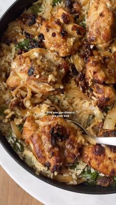 chicken and rice dish in a pan with a spoon on the side, ready to be eaten