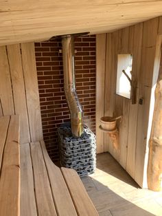 a wooden bench sitting next to a brick wall