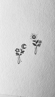 three flowers are drawn on paper with black ink