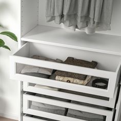 a white shelf with several pairs of shoes on it