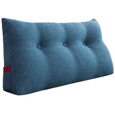 a blue pillow with buttons on the front and back of it, against a white background