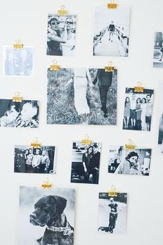 a white wall with many pictures hanging on it's sides and gold pins attached to them