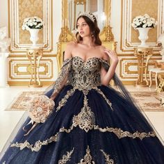 a woman in a blue and gold ball gown