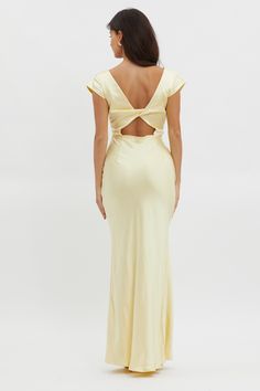 the back of a woman wearing a yellow dress