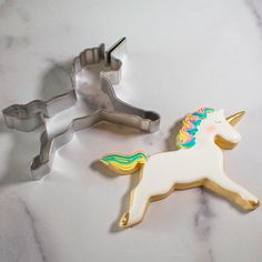 two cookie cutters shaped like unicorns sitting next to each other