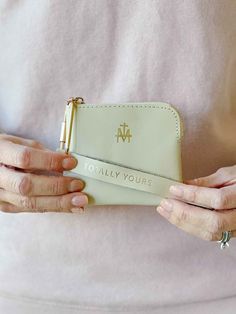 Our Marian Wristlet is made of genuine leather and while originally designed to easily carry around your rosary with you, it also makes a beautiful wallet. Attach your keys to the keychain and slide onto your wrist for both fashion and functionality! On the handle, it is embossed in gold: "totally yours", a phrase often used by Pope Saint John Paul to Our Lady. Wallet: 4.25" x 3.5" Strap: 6" Genuine leather Ethically made in China This beautiful piece is designed by Be A Heart Out of stock? This Gold Rectangular Wristlet For Gifts, Gold Wristlet With Wrist Strap For Everyday Use, Gold Adjustable Wristlet For Everyday Use, Catholic Candles, Catholic Family, Short Messages, Saint John, John Paul, Catholic Gifts