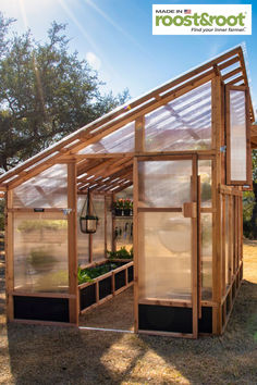 a small wooden greenhouse with plants growing in it and the words rootstroot above it