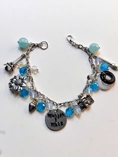 a charm bracelet with charms on it and an i love my mom written on the clasp