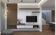 a modern living room with white walls and wood accents, including a flat screen tv