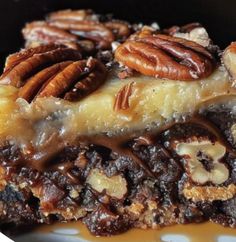 a close up of a slice of pecan pie on a plate with caramel sauce