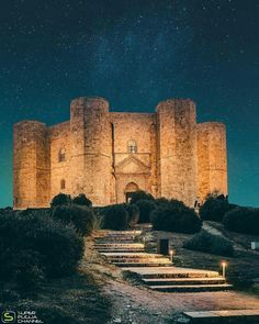 an old castle with stairs leading up to the top and stars in the sky above