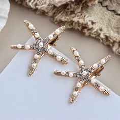 What can be more appropriate for a relaxed beach wedding than these starfish hair clips! They can be the perfect addition to your hair style, or a hair accessory for your Bridesmaids or Flower Girls to match your wedding theme and the vibe of the sea. Adorned with glowing pearls crystals on a gold / silver base, the design coordinates with any hair style and any color wedding dress. The sturdy clip mechanism on the back will attach to your hair and keep it securely in place. The sea star measure Summer Beach Hair, Starfish Hair Clip, Stone Cold Fox, Jennifer Behr, Cheap Hair Products, Bridal Hair Clip, Bohemian Beach, Stone Cold, Flower Hair Pin