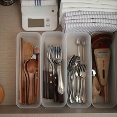 an organized drawer with utensils and spoons