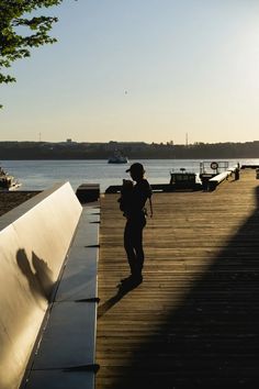 a person with a backpack walking on a dock