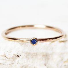 A dainty tiny birthstone ring, made with 14k gold fill! Set with a single Sapphire imitation Cubic Zirconia for your birthstone month. ∙ Gift Ready in a jewelry box! ∙ Handmade in Vancouver, Canada.  ∙ 100% 14k Gold Fill ∙ Rings Sold Individually --------------------------------- M E A S U R E M E N T :  Width: 1.25mm  Gemstone: 2mm Size: Optional (US measurement) If your ring size is not specified as an option, please message me directly so we can create a custom ring together!  --------------- Simple Round Band Birthstone Ring, Stackable Rings With Birthstone In Recycled Gold, Stackable Birthstone Rings In Recycled Gold, Gift Stackable Rings With Birthstone And Recycled Gold, Dainty Gold Sapphire Birthstone Ring, Recycled Gold Birthstone Ring For Promise, Promise Ring With Birthstone In Recycled Gold, Sapphire Stackable Promise Rings With Birthstone, Gift Stackable Birthstone Rings In Recycled Gold