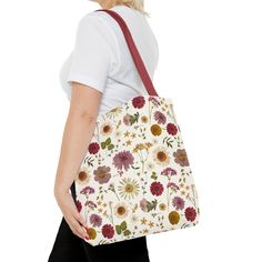 Embrace your free spirit with our stunning Wildflower Tote Bag, a delightful fusion of whimsy and practicality. Crafted with love and care, this tote bag features a vibrant array of bohemian-inspired floral patterns that will instantly transport you to a blooming garden oasis. Each flower and leaf is intricately designed, adding a touch of artistry to your everyday ensemble. Specifications Material: 100% polyester, (handle 100% cotton) Sizes: 13'' x 13'', 16'' x 16'', & 18' 'x 18'' Interior: Non-woven laminate lining White Botanical Style Bags For Everyday, White Botanical Bags For Everyday, White Botanical Bag For Daily Use, White Botanical Bags For Daily Use, White Floral Print Bags As Gifts, Bohemian Bags With Floral Print For Daily Use, White Bags With Plant Print For Daily Use, Everyday White Bags With Plants Print, White Bag With Plant Print For Daily Use