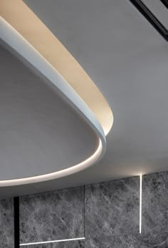 a modern bathroom with grey marble walls and flooring, along with white fixtures on the ceiling