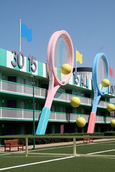 two giant tennis rackets are in front of a building