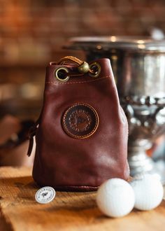 Our Essentials Leather Golf Pouch is made with Premium American leather hides. Store your Wallet, Keys, Flask or any other items during your round. Tough, rugged, durable and built to last. Vegetable-tanned leather embossed logo on the front or initials if you choose.All our bags are handmade in the USA and designed with care and attention to detail. The pouch measures approximately 6” Tall X 5" Wide Formal Textured Leather Pouch, Outdoor Brown Leather Pouch, Luxury Formal Textured Leather Pouch, Classic Soft Leather Pouch For On-the-go, Golf Leather Goods, American Leather, Leather Hide, Embossed Logo, Custom Monogram