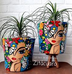 two colorful flower pots with plants in them