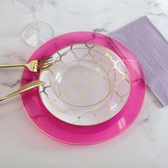 a pink and gold plate with two forks on it