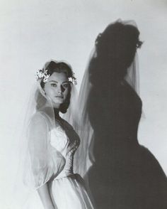 an old photo of a woman in a wedding dress