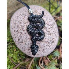 A beautifully carved snake pendant, skilfully hand crafted on both sides from buffalo horn. I have strung this on waxed cotton, which can then be easily adjusted to suit any length, and finished it with a heavy silver metal bead.. Length ....6.4 cm Width...2.5 cm This will arrive presented in a simple but sturdy black box, ideal for a gift or just to keep it safe in... Please have a look at my shop for more incredible products! https://www.etsy.com/uk/shop/SuzieCalypso Black Snake Necklace For Gifts, Black Snake Necklace For Gift, Symbolic Black Hand Cast Jewelry, Handmade Black Snake-shaped Jewelry, Black Snake-shaped Necklaces As Gift, Black Snake Shape Necklace Gift, Black Snake Shape Necklace For Gift, Unique Black Snake-shaped Jewelry, Black Carved Symbolic Necklace